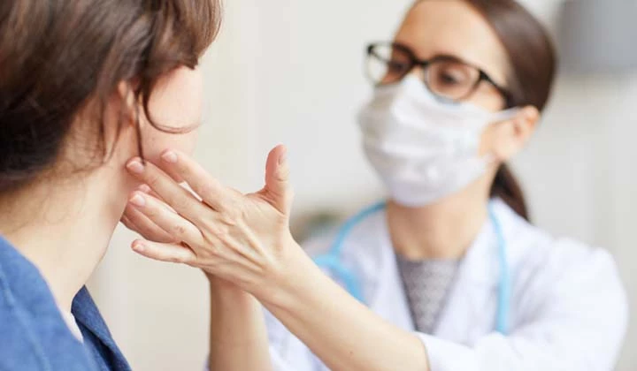 Ärztin prüft einseitige Halsschmerzen Ärztin prüft einseitige Halsschmerzen